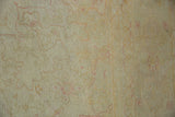 Vintage distressed Oushak rug, worn beige pile with faint foundation and subtle blush patterns.