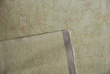 Distressed pile texture and hand-knotted foundation of vintage Oushak rug with secured selvage.