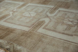 Hand-knotted vintage Kars carpet detail: simplistic palmette designs, abrashed beige field, and even pile wear.
