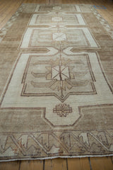 Vintage Kars carpet detail: geometric border, simplistic palmettes in nuanced beige and brown.