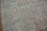 Distressed texture of the Turkish Sparta rug with dusty rose and ivory floral patterns.