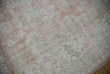 Distressed Sparta carpet section with dusty rose, ivory, and pale slate floral motifs.