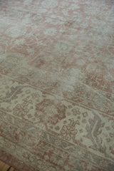 Distressed Turkish Sparta rug detail with curvilinear dusty rose floral design, visible wear.