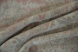 Distressed Sparta rug texture with faded dusty rose, ivory, and slate floral patterns.