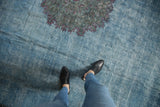Distressed vintage Khorassan rug in sky blue with worn texture and violet medallion detail.