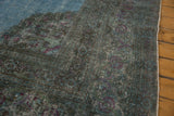 Distressed pile of a vintage Khorassan rug, showcasing teal, sky blue, and violet rose motifs.