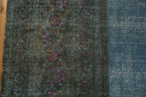 Distressed Khorassan carpet with correction line, revealing teal pattern wear and sky blue field.