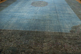 Distressed overdyed Khorassan carpet's sky blue field, showing wear to foundation and dark border.