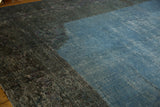 Distressed dark border meeting vibrant sky blue overdyed field, showing wear.