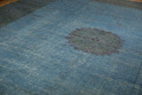 Distressed overdyed sky blue field of a Khorassan carpet, foundation visible with violet medallion.