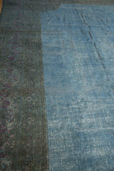 Distressed teal border with violet roses and sky blue field, showing visible foundation.