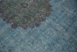 Distressed overdyed teal blue Khorassan carpet with faded violet pattern and visible foundation.