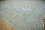Distressed texture and visible foundation of a vintage Mahal carpet with faded blue and beige patterns.