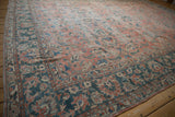Distressed vintage Mahal rug border, featuring rose and dusty teal scrolling vinery with visible knot heads.