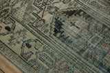 Close-up of distressed vintage Hamadan rug pile, with worn texture and muted earthy, dusty teal colors.