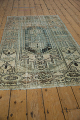 Distressed vintage Hamadan rug corner, with worn fringe and low-pile primitive floral border.