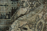 Worn distressed Hamadan rug pile, with primitive geometric patterns in beige, brown, and dusty teal.