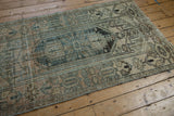Distressed texture, primitive motifs in faded apricot, dusty teal, olive green, showing even wear.