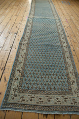 Distressed Mir Sarouk runner's repeating boteh pattern and geometric Serbend border.