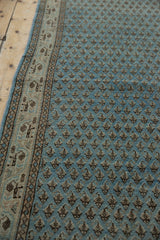 Distressed vintage Mir Sarouk runner: dusty blue boteh field and geometric border detail.