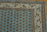 Distressed vintage Mir Sarouk runner corner, showing pale sky blue botehs and multi-tone geometric border.