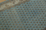 Distressed vintage Mir Sarouk rug detail showing staggered botehs, Serbend border.
