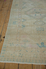 Worn ivory field of vintage Serab runner, with blue lattice, pawn motif, and intact selvage.