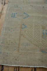 Vintage Serab rug runner's secured side cord with muted blue pawn design motifs.