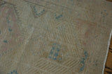 Close-up of vintage Serab rug showing worn pile, visible knot heads, and faded blue details.