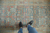 Low-pile texture and decorative wear on a vintage Hamadan runner with blue and terracotta vinery.