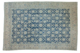 Distressed vintage Tabriz carpet showcasing faded denim blue and ivory Safavid floral lattice, 7'3