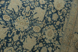 Distressed Tabriz carpet with Safavid palmettes, vines, and worn denim blue palette.