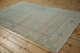 Vintage Distressed Hamadan rug corner, subtle blue boteh field, time-softened floral border.