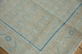 Soft blue boteh patterns and dark blue serrated border detail of a distressed Hamadan rug.