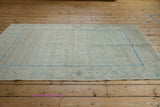 Distressed Hamadan rug's intact side selvage with soft blue serrated floral border.