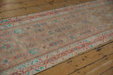 Angled view of the distressed Hamadan runner's repeating Herati pattern and low-pile texture.