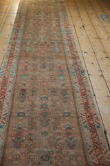 Perspective view down the length of the distressed Hamadan runner showing its allover pattern.