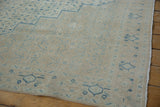 Detail of the vintage Birjand carpet's evenly worn pile and geometric blue Herati design.