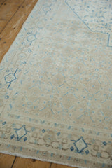 Even wear across the knot heads of a vintage rug with sand and sky blue geometric designs.
