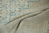 Soft drape of a distressed Birjand carpet showing its even wear and texture.