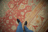 Vintage Oushak carpet with cinnabar red, ivory, gold, and jade green floral arabesques.