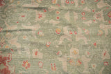 Seafoam green pile of a vintage Oushak rug with cinnabar, ivory floral arabesques.