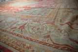 Vintage Oushak rug's muted cinnabar and ivory floral vinery with even pile wear.