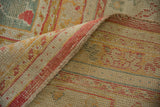 Detail of vintage Oushak carpet's hand-knotted pile, showing foundation and red corded selvage.