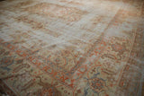 Worn Herati motif field and terra cotta samovar serrated leaf border on vintage Amritsar rug.