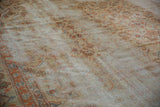 Angled detail of vintage Amritsar rug showing worn Herati pattern, exposed foundation, and samovar border.