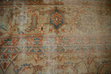 Worn vintage Amritsar carpet detail showing exposed foundation and beige Herati motif.