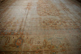 Corner of Amritsar carpet: terra cotta samovar sickle border and worn Herati field.