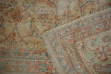 Worn beige, terra cotta Herati pattern, showing foundation and hand-knotted reverse.