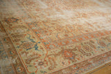 Vintage Amritsar rug corner with beige Herati motif, terra cotta samovar border, and wear.
